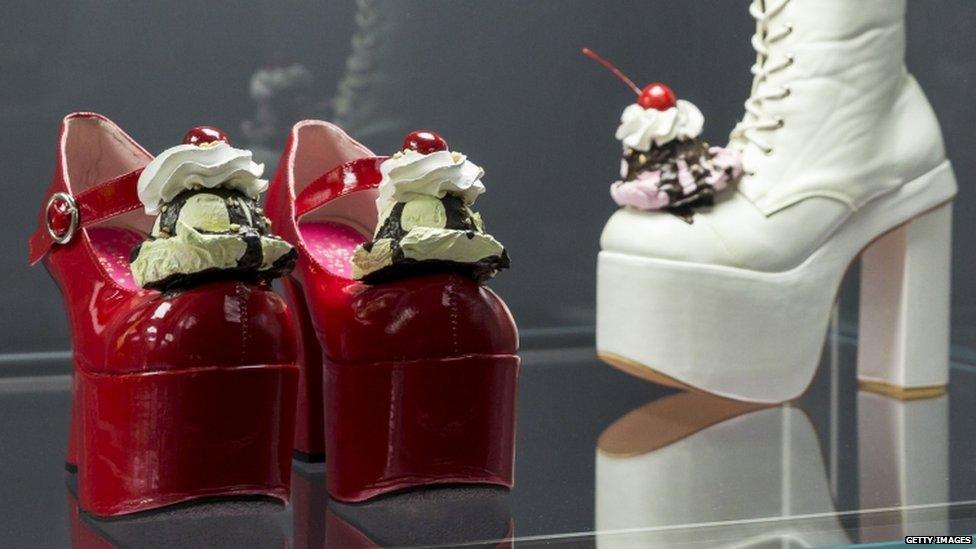 Shoes with ice-cream and cream piled on the toe.