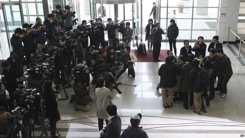 An unidentified South Korean man is surrounded by the media after returning from the North Korean city of Kaesong, April 3, 2013