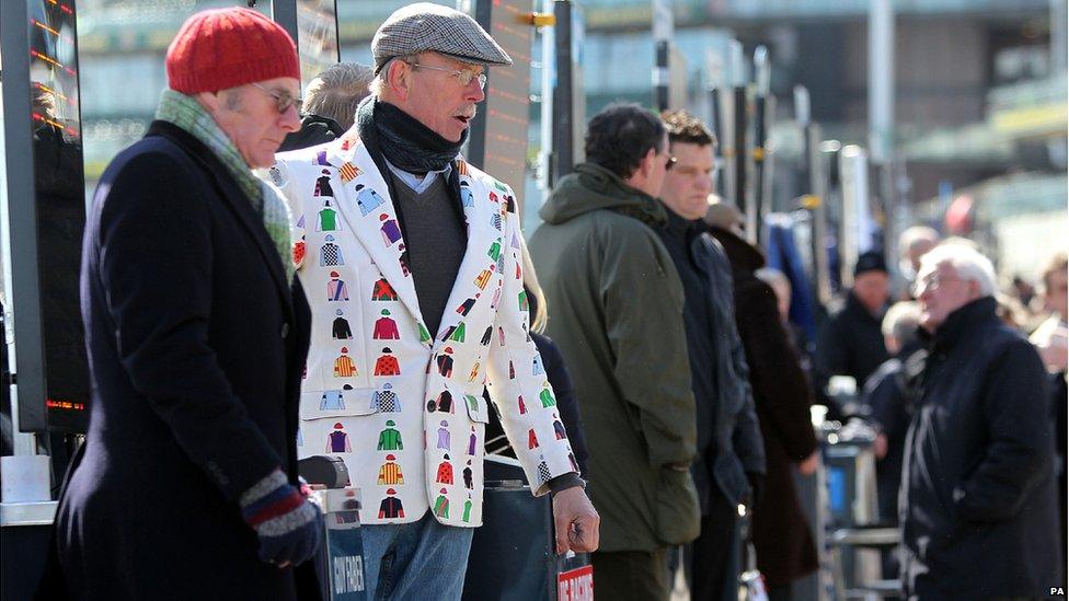 Bookmaker in horse racing colours jacket at Aintree