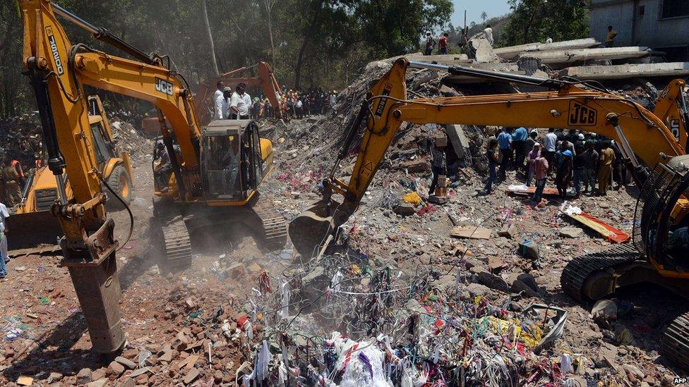 Excavators clear debris in Thane, Mumbai, on 5 April 2013