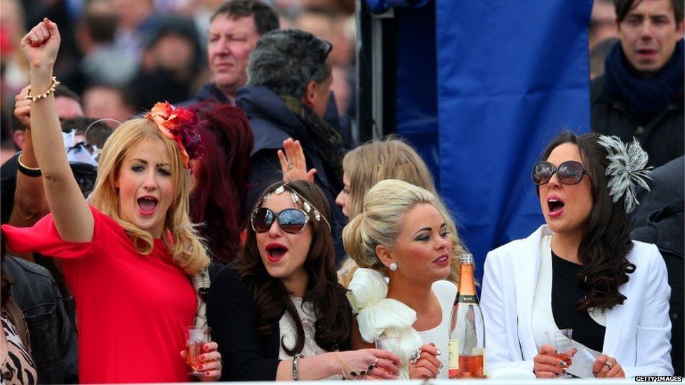 Woman cheering on horses at Aintree