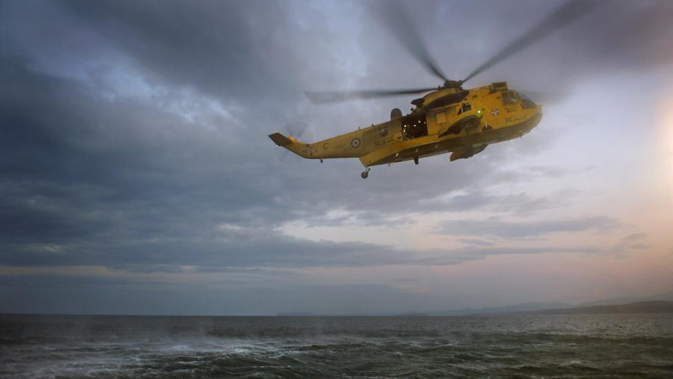 Search and rescue helicopter in flight over the sea, piloted by Prince William