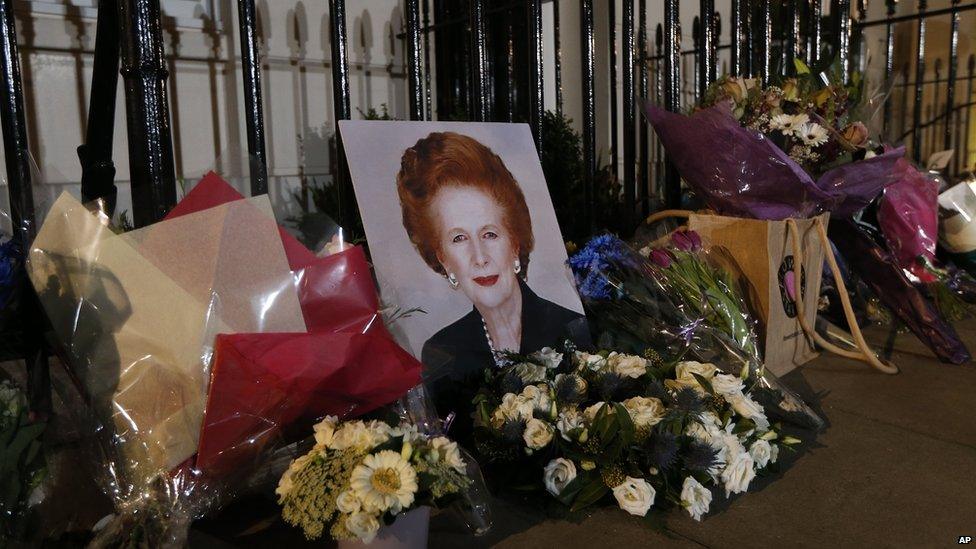 Flowers placed by well-wishers surround a portrait of former British prime minister Margaret Thatcher outside her home in Belgravia, London.