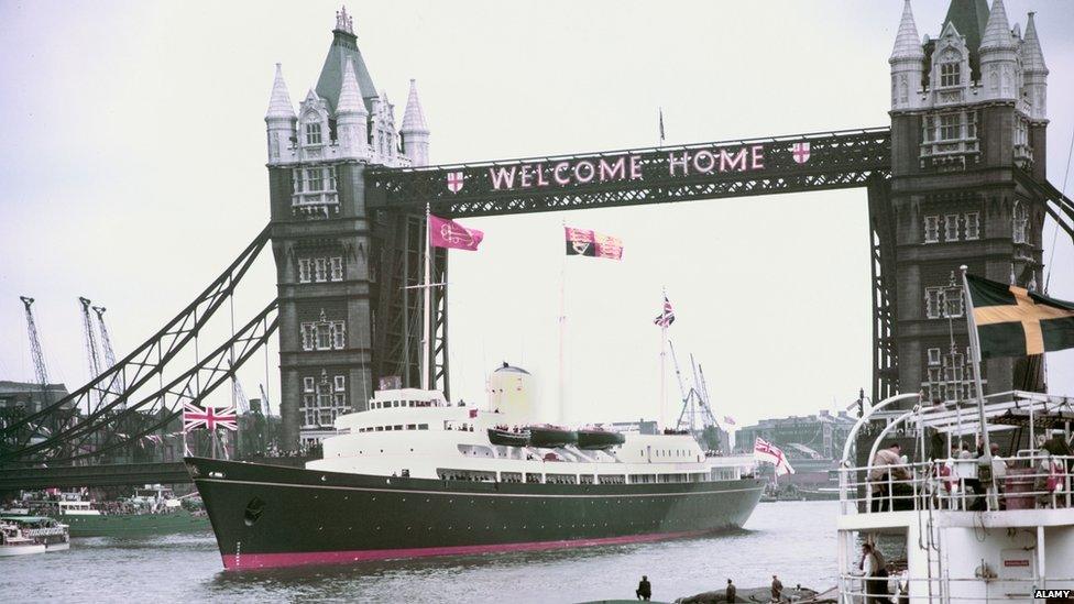 The Royal Yacht Britannia passing under Tower Bridge, London