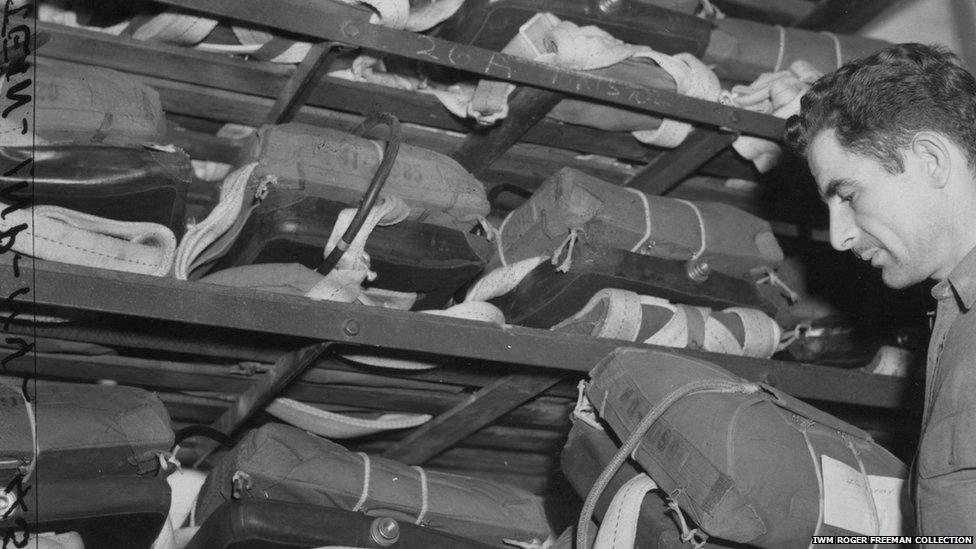 Tech Sgt Francis Scott Kee packs away parachutes at Duxford