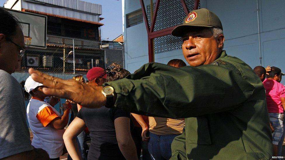 A Venezuelan military officer instructs citizens in Caracas where to line up to vote