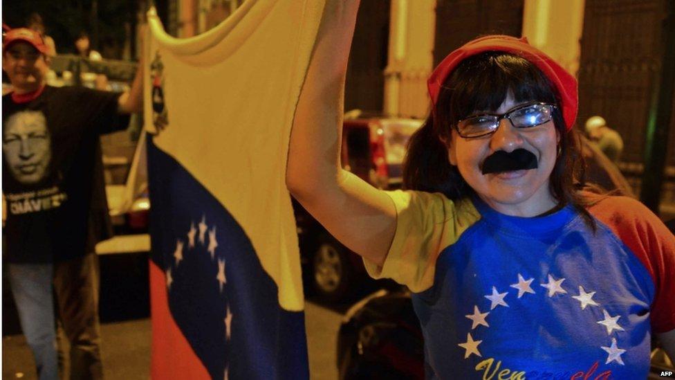 Supporter of Nicolas Maduro, with a fake moustache, celebrates his win in the presidential election