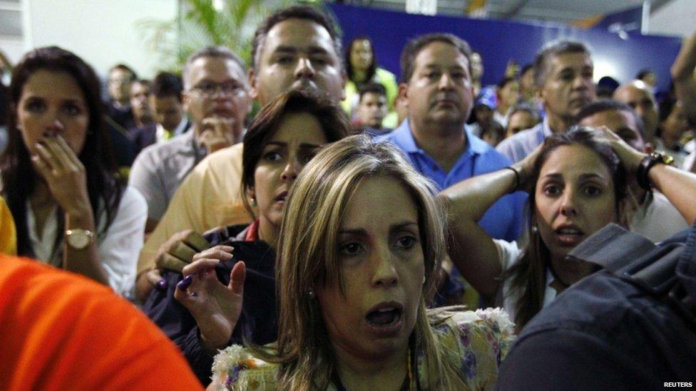 Supporters of defeated candidate Henrique Capriles react to the news of Mr Maduro's win