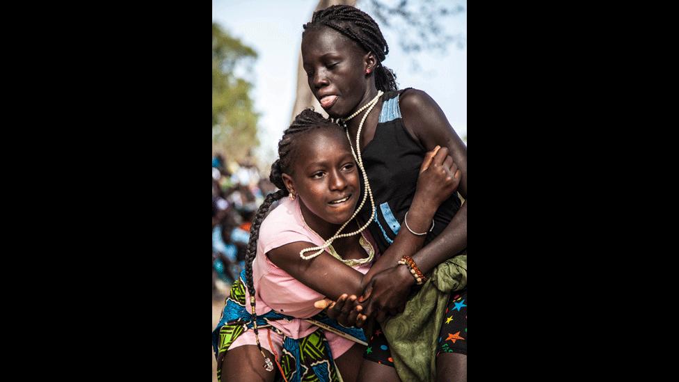 A girl wrestles while wearing jewellery