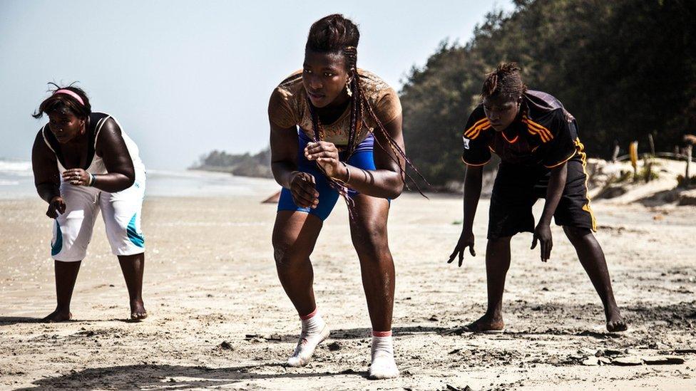 From left to right, Aissatou Diba, 20, Sirefina Diediou, 19 and Aminata Diatta, 16, training on a beach in the village of Diembering, Casamance.