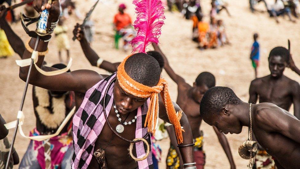 Dancers knock spears into ground