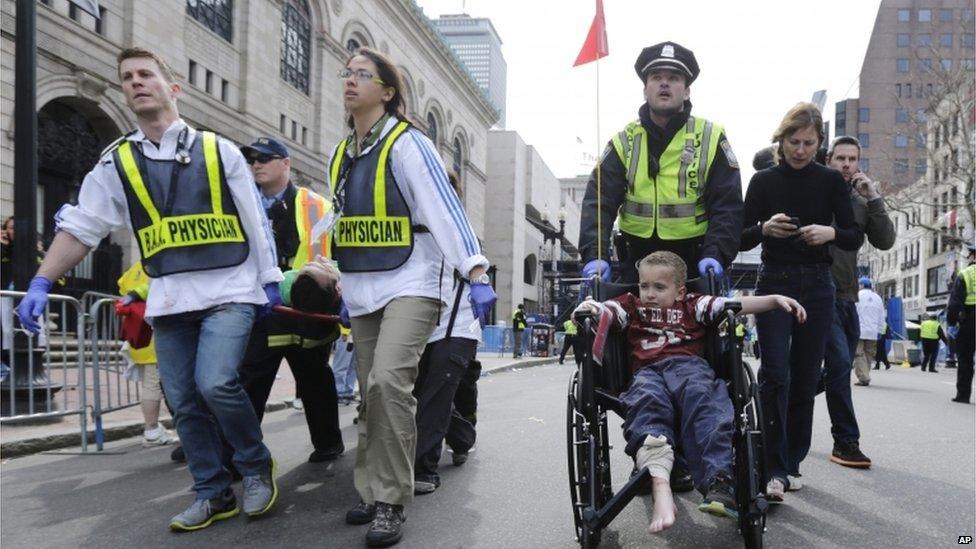 Medical workers take injured people away from the scene, 15 April 2013