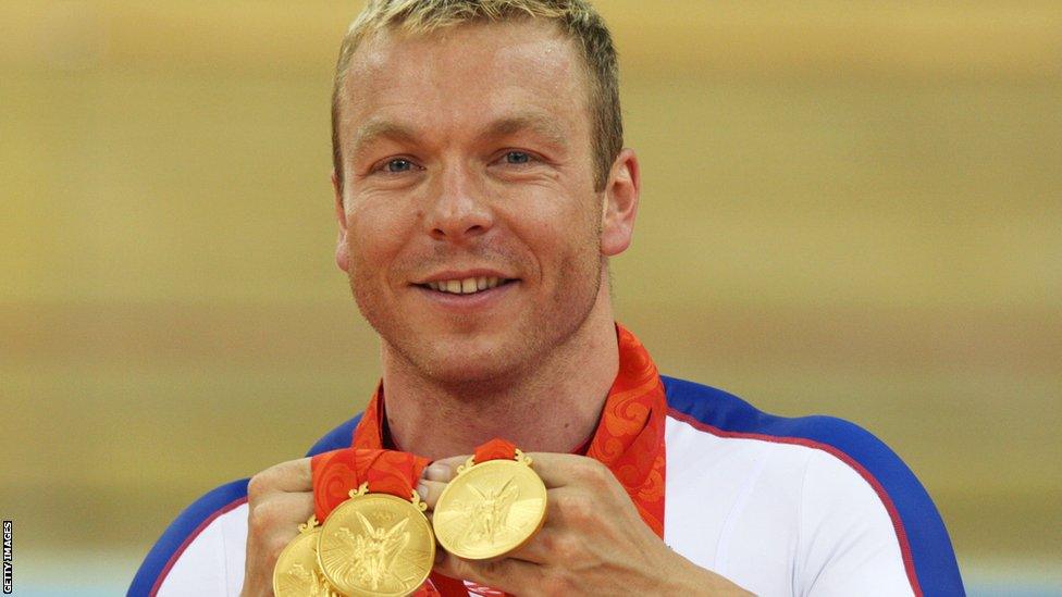 Chris Hoy poses with the gold medals won during the 2008 Beijing Olympic