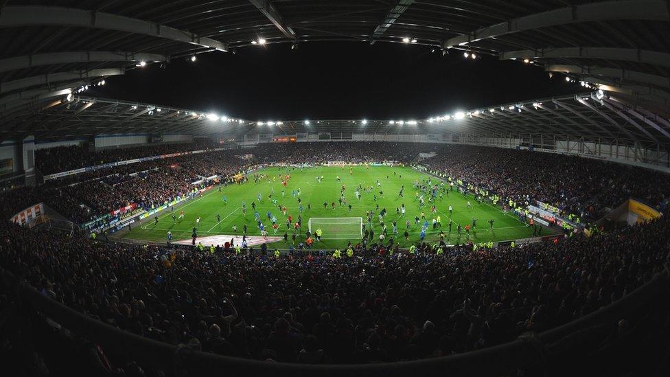 Cardiff City fans run onto the pitch