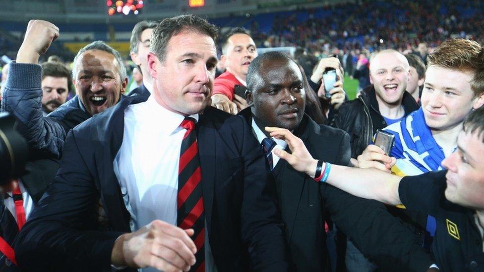 Cardiff City manager Malky Mackay is mobbed by fans