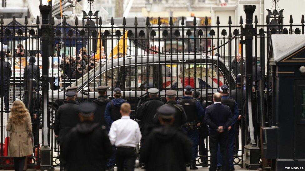 A hearse carrying the coffin of Baroness Thatcher passes the gates of Downing Street