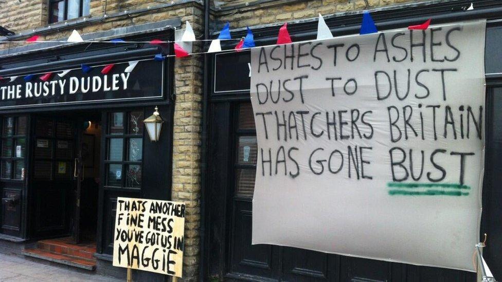 Anti-Margaret Thatcher messages written on a placard and a sheet