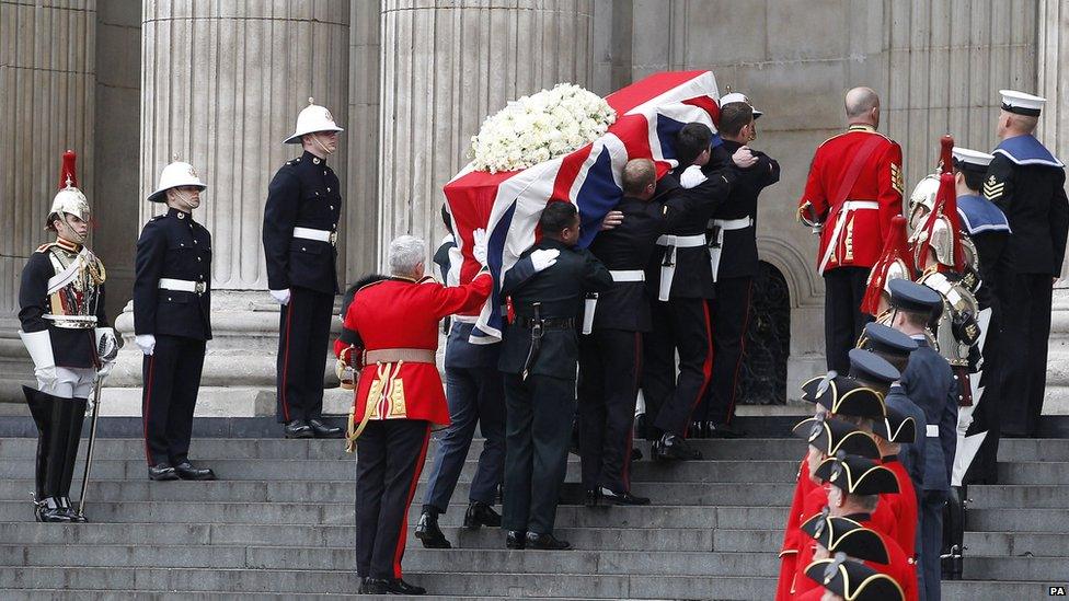 The coffin of Baroness Thatcher is carried aloft by members of the armed forces prior to her funeral.