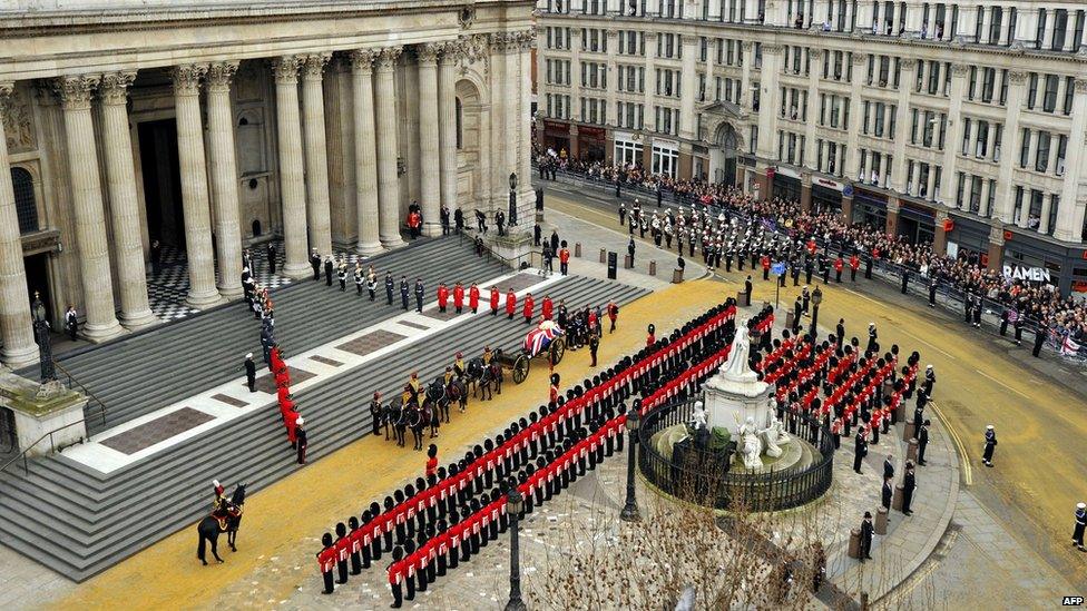 The coffin of British former prime minister Margaret Thatcher, carried on a gun carriage drawn by the King's Troop Royal Horse Artillery, arrives at St Paul's Cathedral during her ceremonial funeral in central London on April 17, 2013.