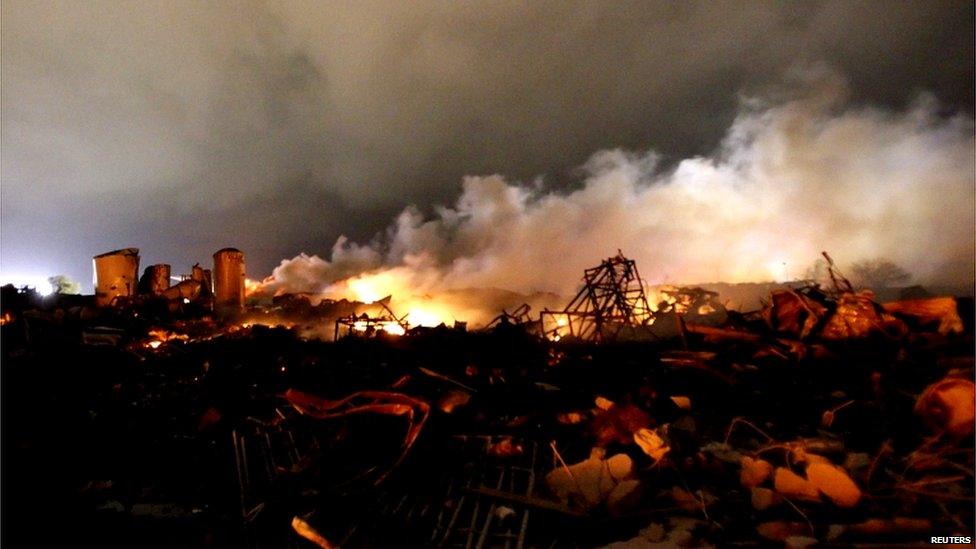 The remains of the plant continue to burn. Emergency services officials said ammonia may have caused the explosion.