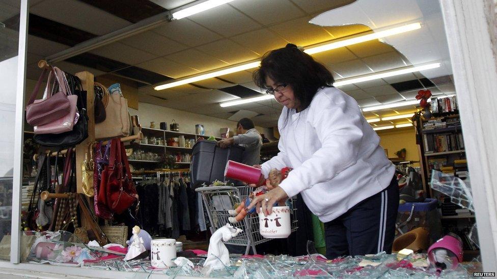 Workers clean up debris caused by the blast in the West Thrift Shop in Waco (18 April 2013)