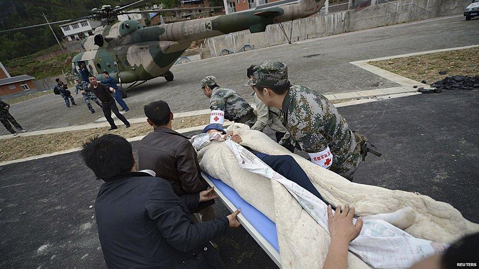 Rescuers rush to carry a victim onto a helicopter after a strong 6.6 magnitude earthquake hit Taiping town of Lushan county, Sichuan province April 20