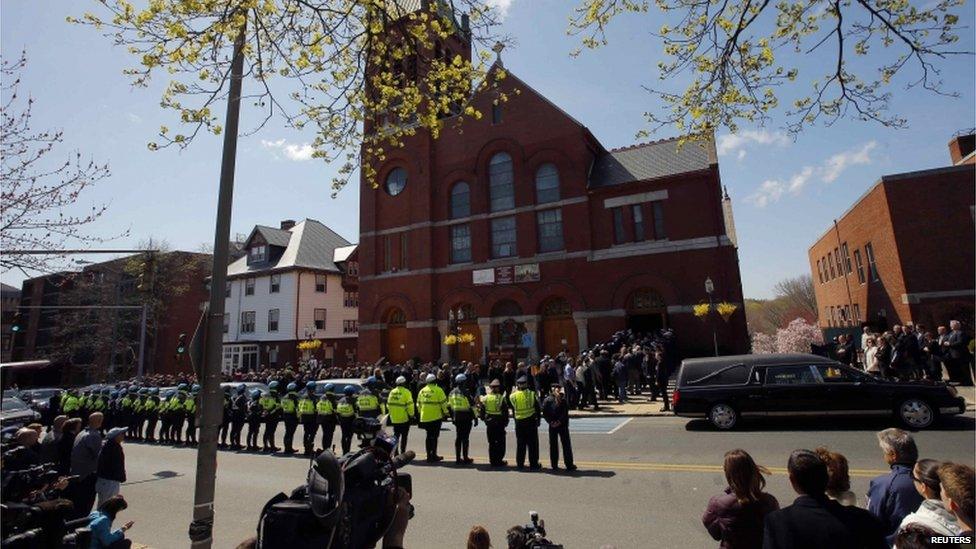 Policemen, friends and family of Krystle Campbell line the street outside St Joseph Church, 22 April