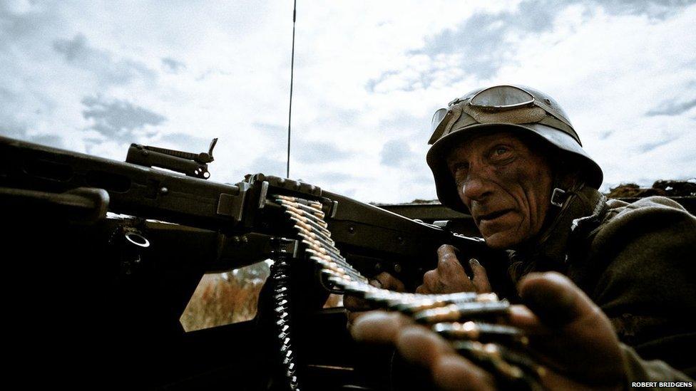 WWII re-enactment featuring a German gunner