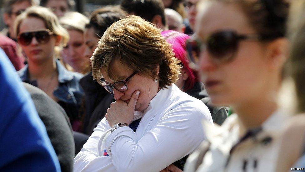 People observe a public silence on Boylston Street, Boston, 22 April