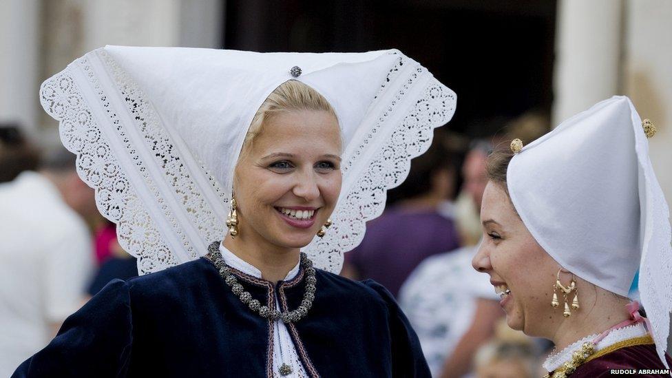 Croatian women in traditional local folk costume, during a procession on Assumption Day on the island of Pag. Following an all night vigil, a statue of the Virgin Mary is carried from a shrine in the old town to the Church of the Assumption of the Virgin Mary in the town centre.