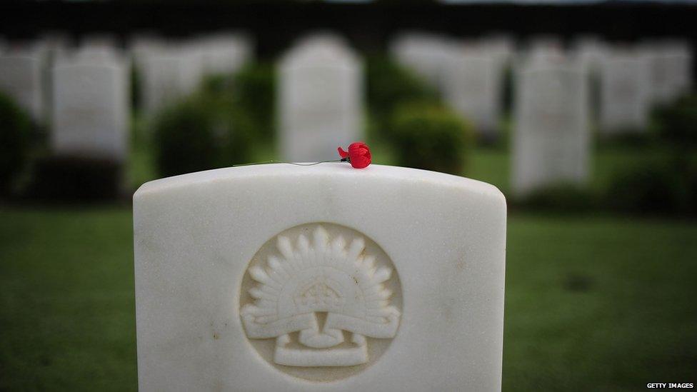 A single red poppy is seen laying on top of a headstone at the Belgian Gardens war cemetery on 25 April 2013 in Townsville, Australia