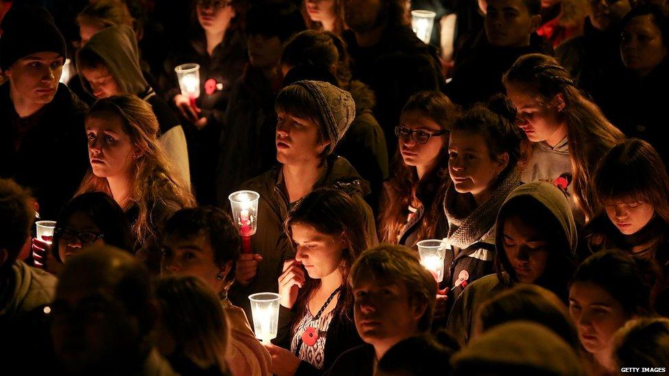Members of the public hold candles during dawn service at the Wellington cenotaph on 25 April 2013 in Wellington, New Zealand