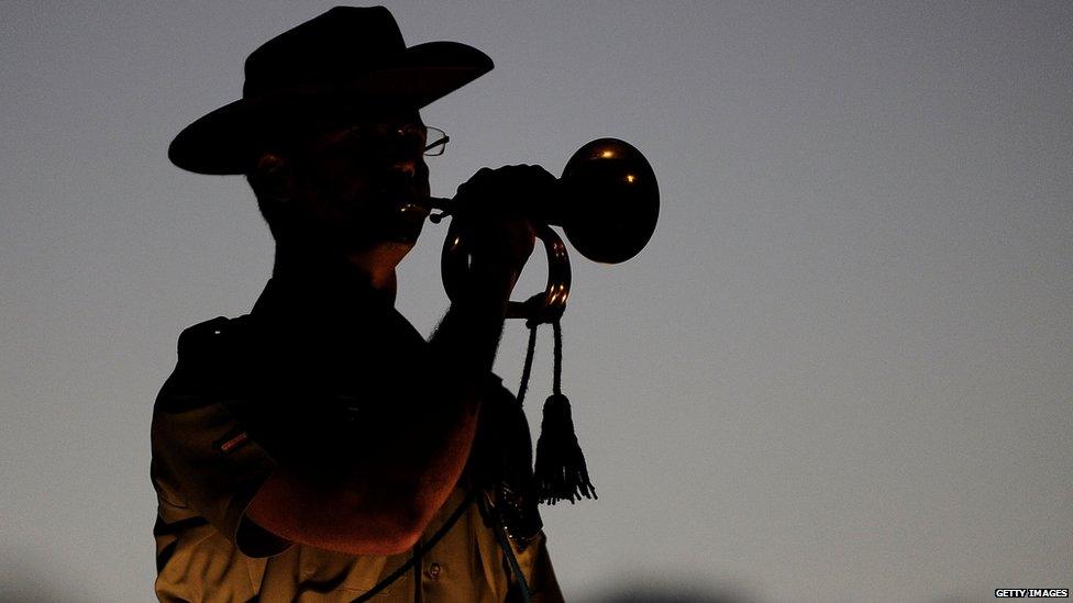 An Australian army soldier plays the the last post at the dawn service on 25 April 2013 in Townsville, Australia