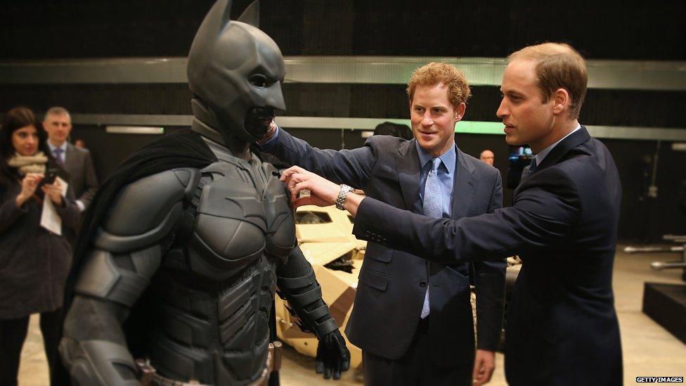 Prince William, Duke of Cambridge and Prince Harry look at a Batsuit