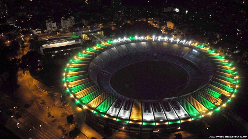 Aerial view of the Maracana stadium emitting light beams of the Brazilian national colours, yellow and green, in Rio de Janeiro on June 16, 2010