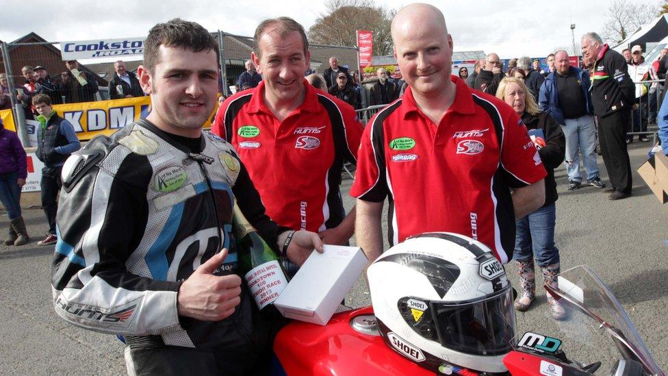 Michael Dunlop celebrates his two Cookstown 100 Superbike wins with members of his team
