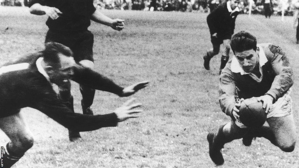 1959: 26th September 1959: British Lions' fly half Bev Risman scores in the rugby final Test match against New Zealand in Auckland. DB Clarke leaves the tackle too late.