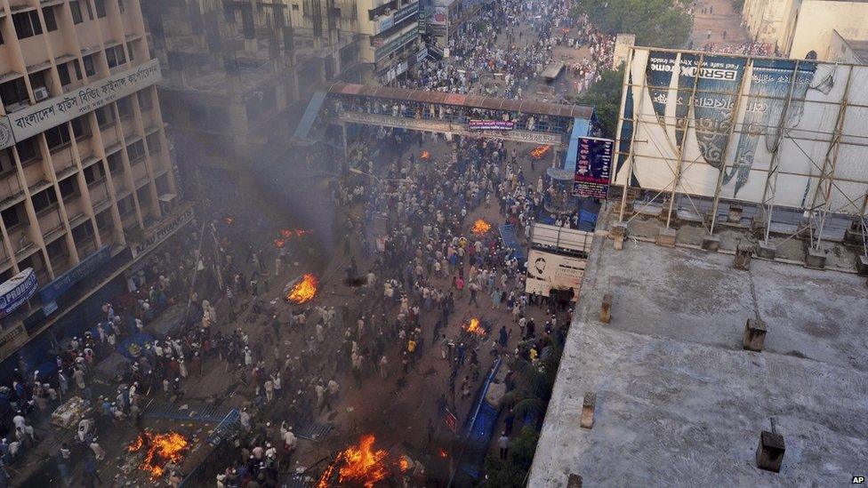 Protesters start fires in the streets of Dhaka, Bangladesh, on 5 May 2013