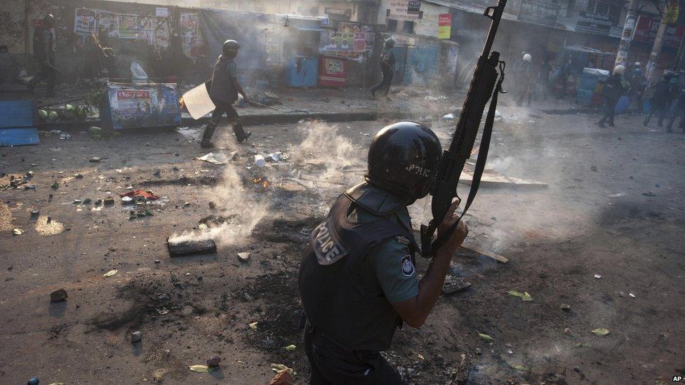 Bangladeshi policemen walk through the streets of Dhaka on 5 May 2013