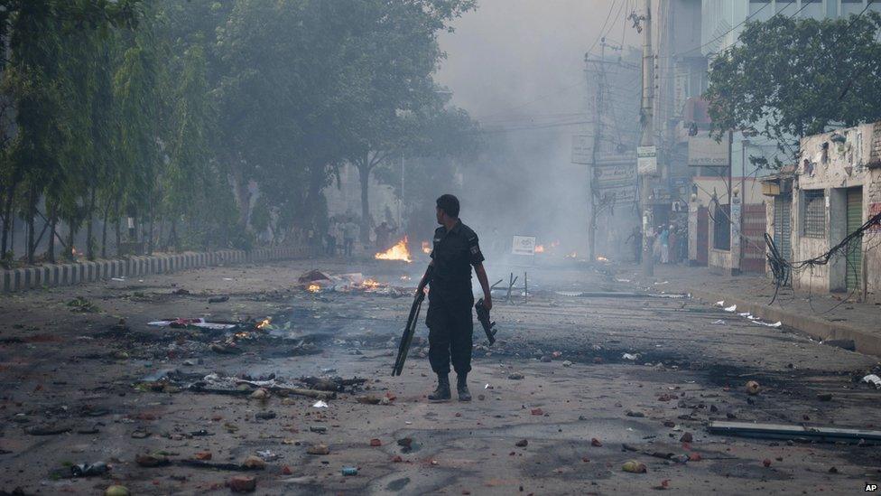 Bangladeshi policeman walks through the streets of Dhaka on 5 May 2013