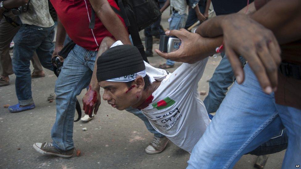 Injured activist is carried away during protests in Dhaka, Bangladesh, on 5 May 2013