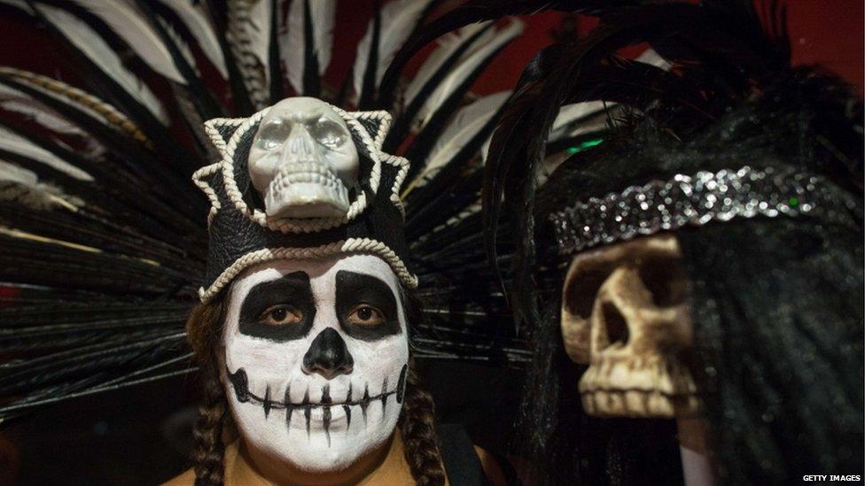 A performer wears a headdress with a skull at the Cinco de Mayo celebrations in Los Angeles