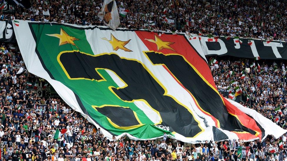 The Juventus fans pass along a giant banner in Juventus Stadium with '31' on it, a figure that represents the club's total number of Serie A title wins, plus the two won in 2005 and 2006 which were subsequently stripped because of a match-fixing punishment