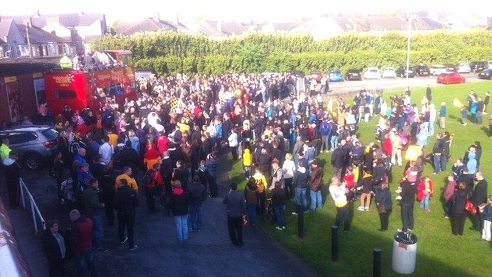 Newport County fans gather at Rodney Parade to greet the bus