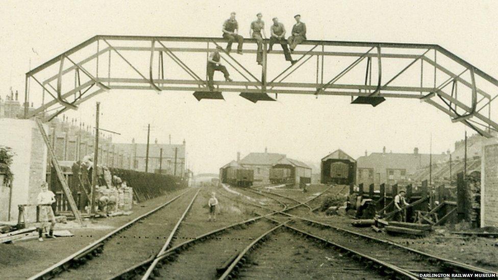 Men sitting on a bridge