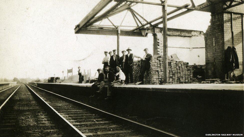 Men sitting on a platform
