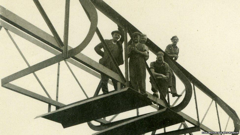 Men standing on a bridge