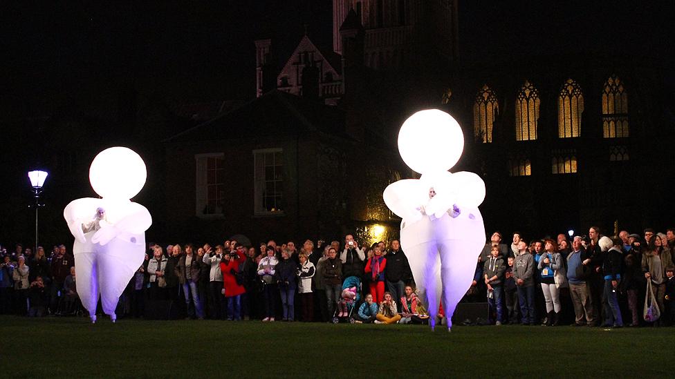 Characters from Herbert's Dream by Compagnie des Quidams performing in Norwich's Cathedral Close