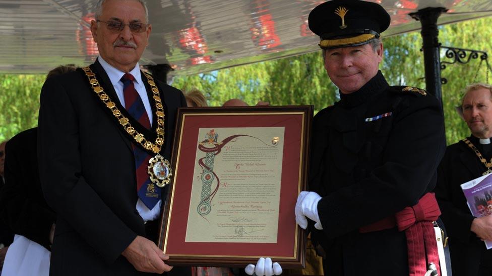 Mayor Doug Williams hands the freedom scroll to Col Tom Bonas