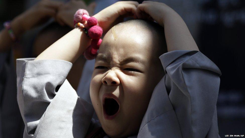 Boy yawns while attending a volunteer activity in Seoul, South Korea (16 May 2013)